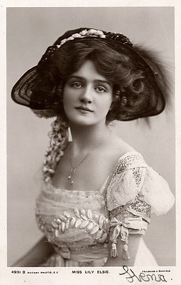 Picture of an Edwardian woman wearing a big hat and a flowy dress.
